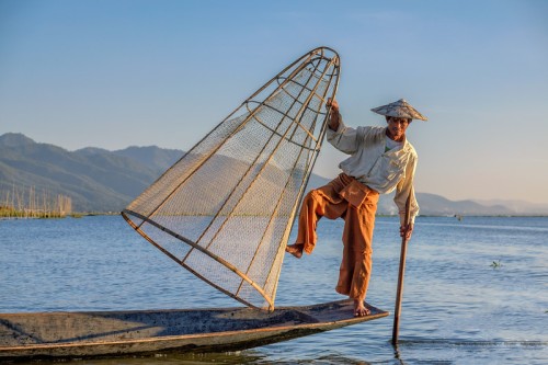 "Balancing act by Inle lake fisherman"